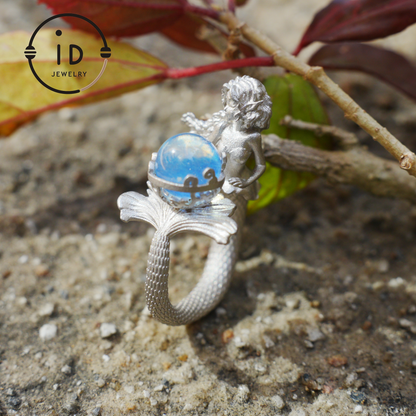 Handmade silver ring with seated mermaid and aquamarine stone, symbolic fantasy jewelry gift for women and ocean-inspired fairytale lovers