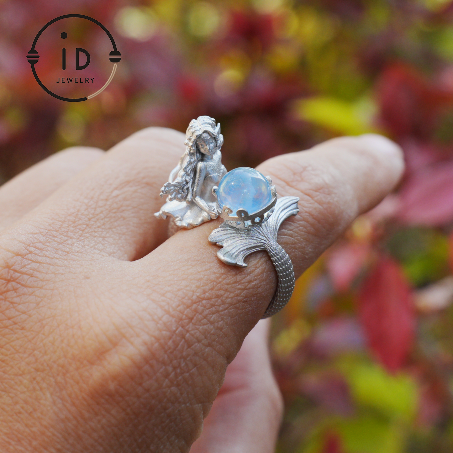Handmade silver ring with seated mermaid and aquamarine stone, symbolic fantasy jewelry gift for women and ocean-inspired fairytale lovers