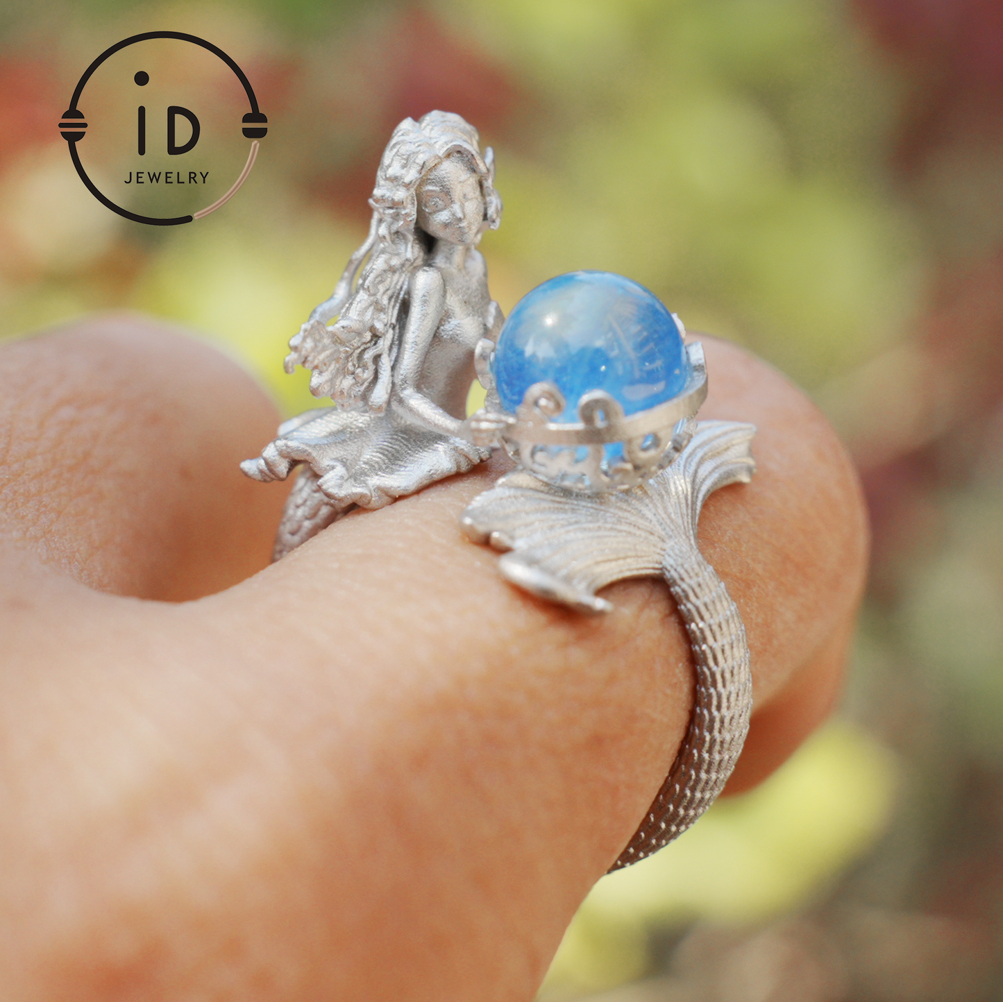 Handmade silver ring with seated mermaid and aquamarine stone, symbolic fantasy jewelry gift for women and ocean-inspired fairytale lovers