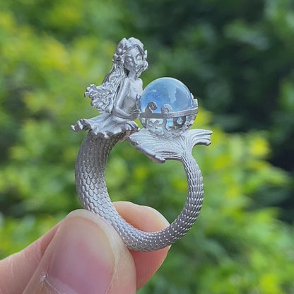Handmade silver ring with seated mermaid and aquamarine stone, symbolic fantasy jewelry gift for women and ocean-inspired fairytale lovers